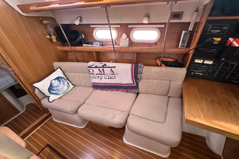 Slide: The Image of Cozy interior of 2006 Catalina 387 sailboat with beige sofa and nautical decor. - 25