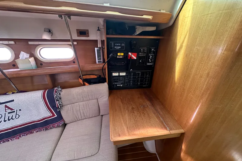 Slide: The Image of Interior of 2006 Catalina 387 sailboat with control panel and cozy seating area. - 26