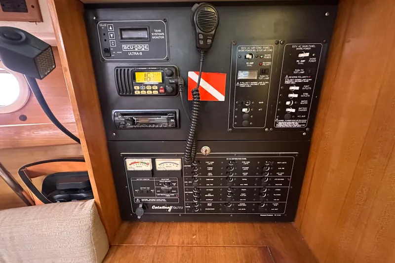 Slide: The Image of Control panel of a 2006 Catalina 387 yacht with various gauges and switches. - 27
