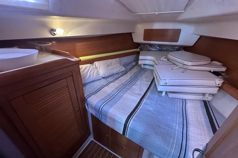 Slide: The Image of Cozy cabin interior of 2006 Catalina 387 sailboat with bed and storage. - 28
