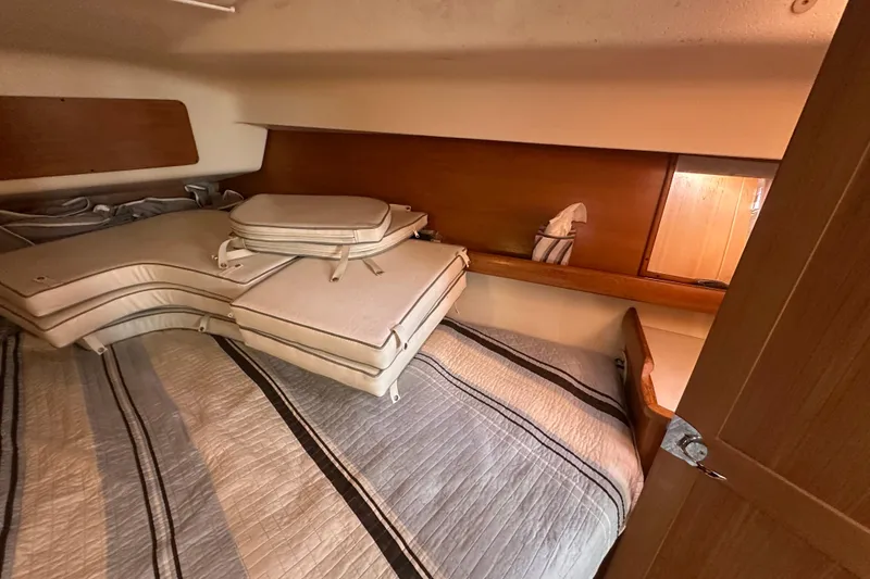 Slide: The Image of Cozy cabin interior of 2006 Catalina 387 sailboat with cushions and bedding. - 29