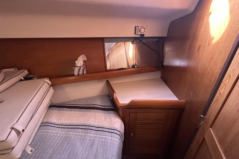 Slide: The Image of Cozy cabin interior of 2006 Catalina 387 sailboat with wooden furnishings and bed. - 30