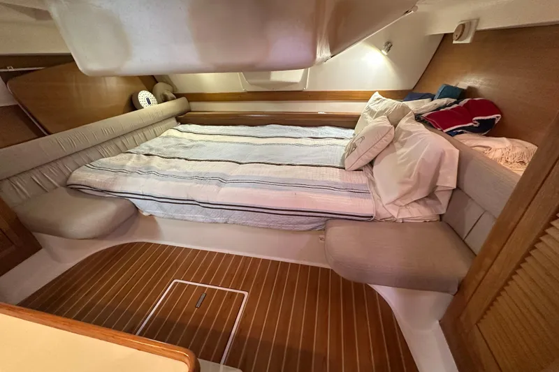 Slide: The Image of Cozy cabin interior of 2006 Catalina 387 sailboat with comfortable bedding and wooden flooring. - 37