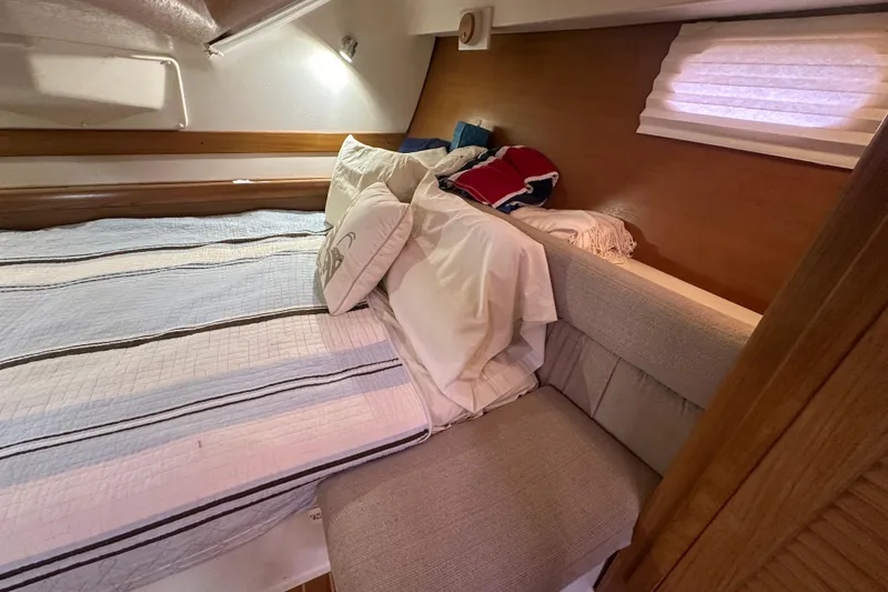 Slide: The Image of Cozy cabin interior of 2006 Catalina 387 sailboat with bed and seating area. - 39