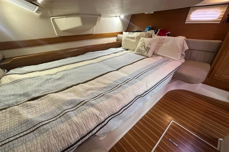 Slide: The Image of Cozy cabin interior of 2006 Catalina 387 sailboat with comfortable bedding and wooden flooring. - 40