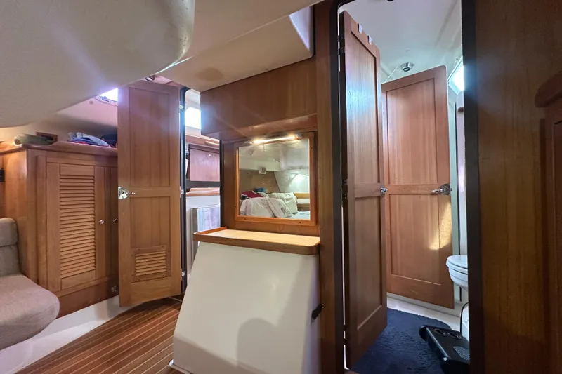 Slide: The Image of Interior of 2006 Catalina 387 sailboat with wooden cabinetry and cozy living space. - 42