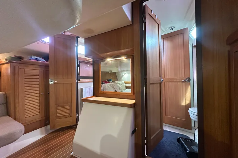 Slide: The Image of Interior of 2006 Catalina 387 sailboat with wooden cabinetry and cozy living space. - 43