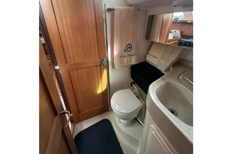 Slide: The Image of Bathroom interior of 2006 Catalina 387 yacht with sink, toilet, and towels. - 45
