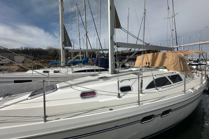 Slide: The Image of 2006 Catalina 387 sailboat docked at marina under cloudy sky. - 9