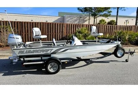 Slide: The Image of 2014 Alumacraft Pro 165 fishing boat with trailer, parked outdoors. - 0