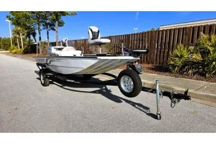 Slide: The Image of 2014 Alumacraft Pro 165 boat on trailer, parked on a sunny street. - 1