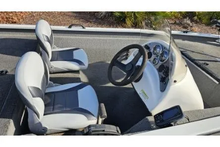 Slide: The Image of 2014 Alumacraft Pro 165 boat interior with steering console and two seats. - 11