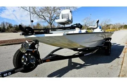 Slide: The Image of 2014 Alumacraft Pro 165 boat on trailer, parked outdoors under clear sky. - 4