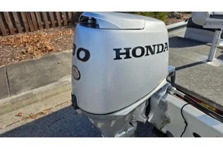 Slide: The Image of 2014 Alumacraft Pro 165 boat with Honda outboard motor, parked on pavement. - 8