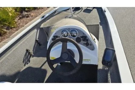 Slide: The Image of 2014 Alumacraft Pro 165 boat dashboard with steering wheel and gauges. - 9