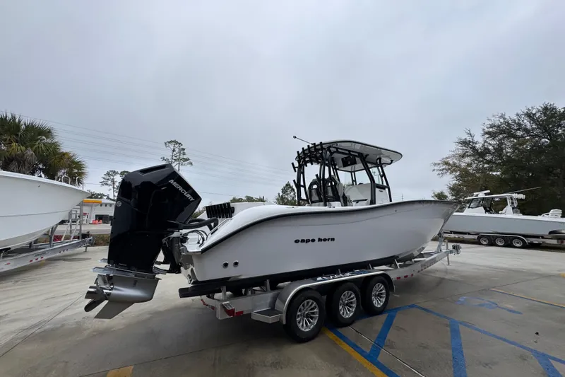 Slide: The Image of 2026 Cape Horn 32 XS boat on trailer, featuring powerful Mercury outboard engine. - 10