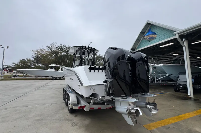 Slide: The Image of 2026 Cape Horn 32 XS boat with dual engines on a trailer at a marina. - 14