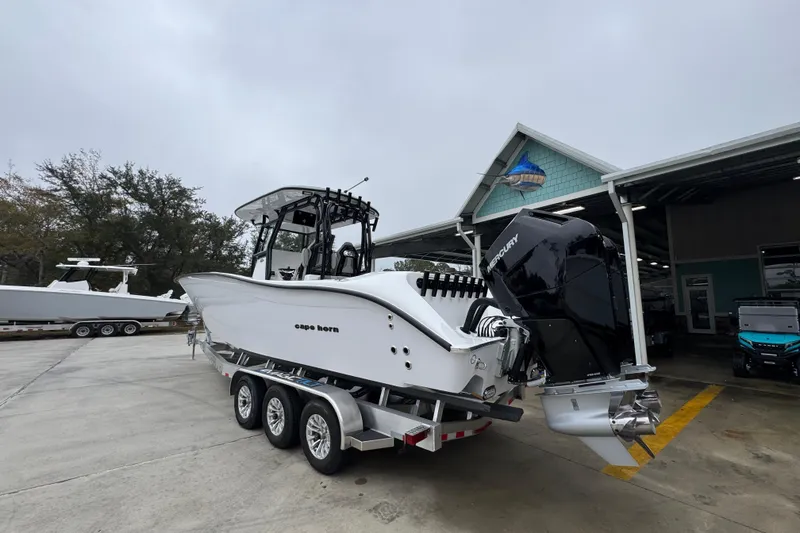 Slide: The Image of 2026 Cape Horn 32 XS boat with dual Mercury engines on a trailer. - 15