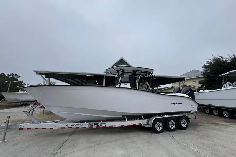 Slide: The Image of 2026 Cape Horn 32 XS boat on trailer, displayed outdoors. - 2