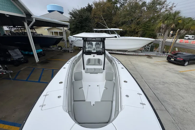 Slide: The Image of 2026 Cape Horn 32 XS boat displayed at a dealership, showcasing sleek design and spacious seating. - 21