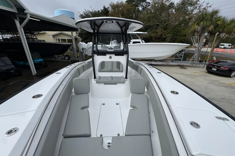 Slide: The Image of 2026 Cape Horn 32 XS boat with sleek design and spacious seating, docked outdoors. - 22