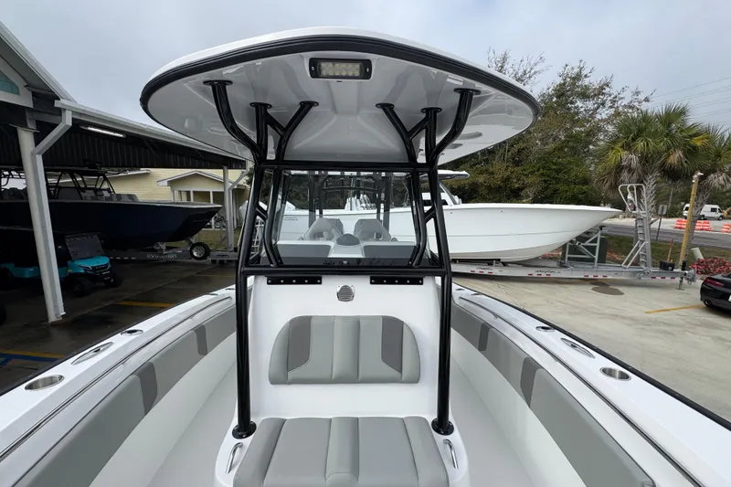 Slide: The Image of 2026 Cape Horn 32 XS boat interior with T-top and seating, docked outdoors. - 23