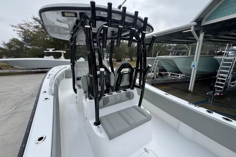 Slide: The Image of 2026 Cape Horn 32 XS boat interior with seating and rod holders, docked at a marina. - 36
