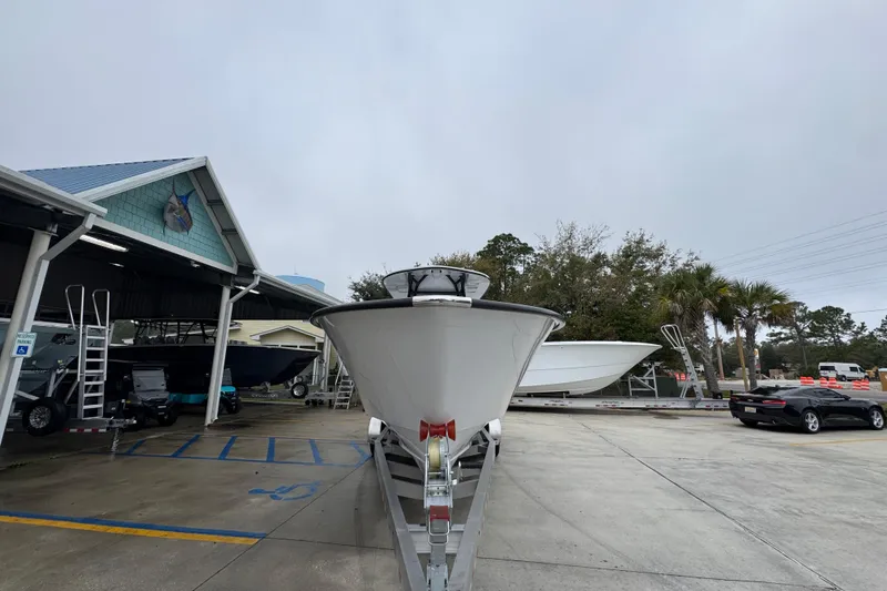 Slide: The Image of 2026 Cape Horn 32 XS boat on trailer at dealership, overcast day. - 5