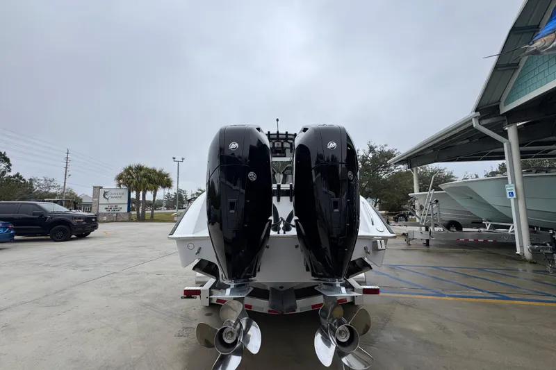 Slide: The Image of 2026 Cape Horn 32 XS boat with dual outboard motors in a marina setting. - 13