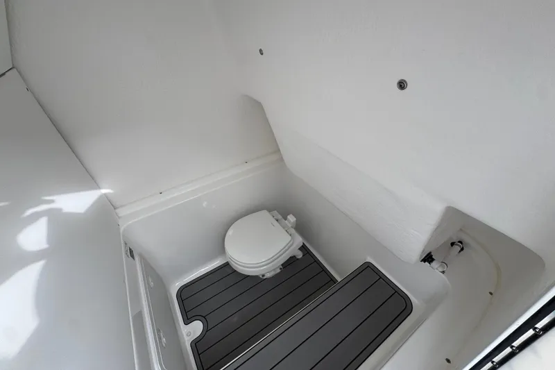 Slide: The Image of 2026 Cape Horn 32 XS boat interior with compact marine toilet and non-slip flooring. - 26