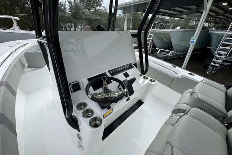 Slide: The Image of 2026 Cape Horn 32 XS boat interior with steering console and seating. - 27
