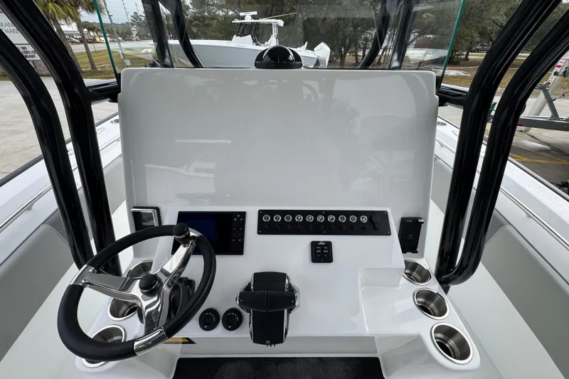 Slide: The Image of 2026 Cape Horn 32 XS boat dashboard with steering wheel and control panel. - 28