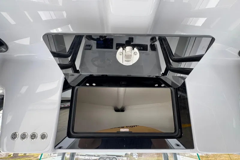 Slide: The Image of 2026 Cape Horn 32 XS boat console with storage compartment and control panel. - 31