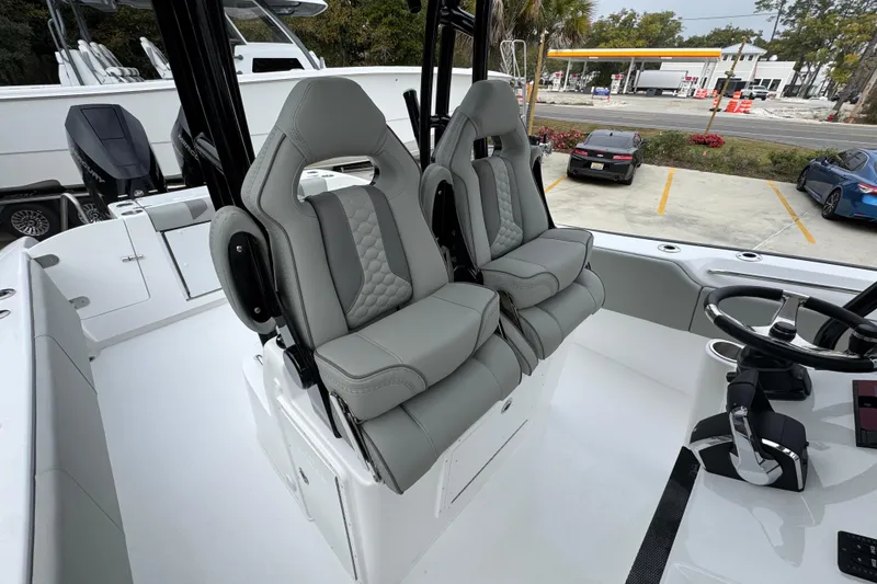 Slide: The Image of 2026 Cape Horn 32 XS boat interior with dual gray captain seats and steering wheel. - 35
