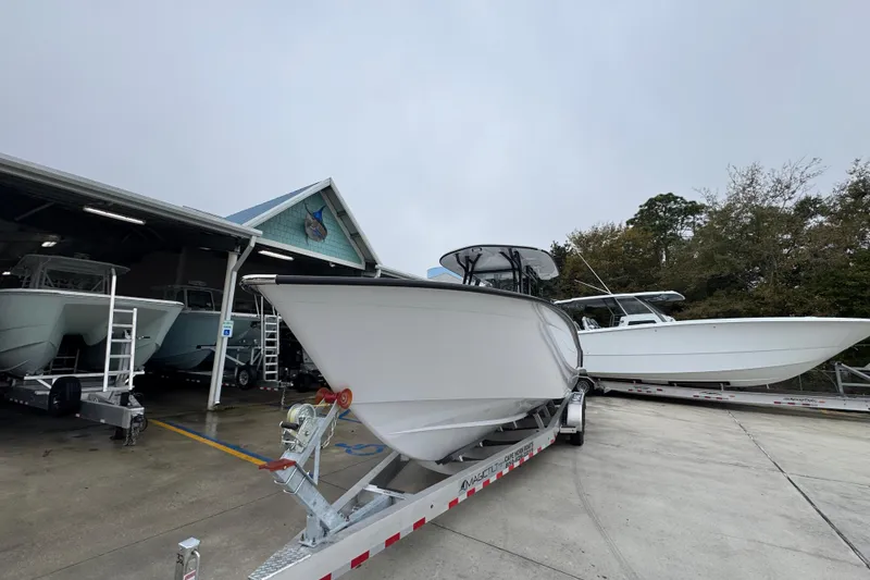 Slide: The Image of 2026 Cape Horn 32 XS boat on trailer at marina, overcast sky. - 4