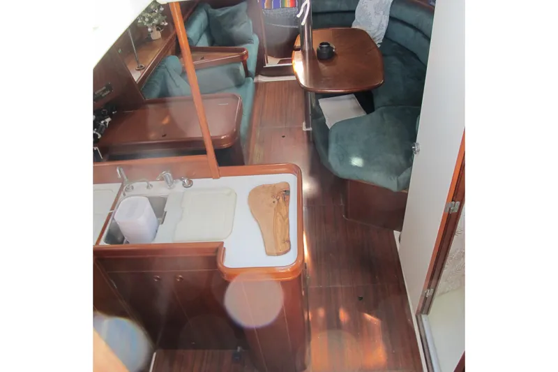 Slide: The Image of Interior of 2000 Beneteau Oceanis 361 sailboat with kitchen and seating area. - 16