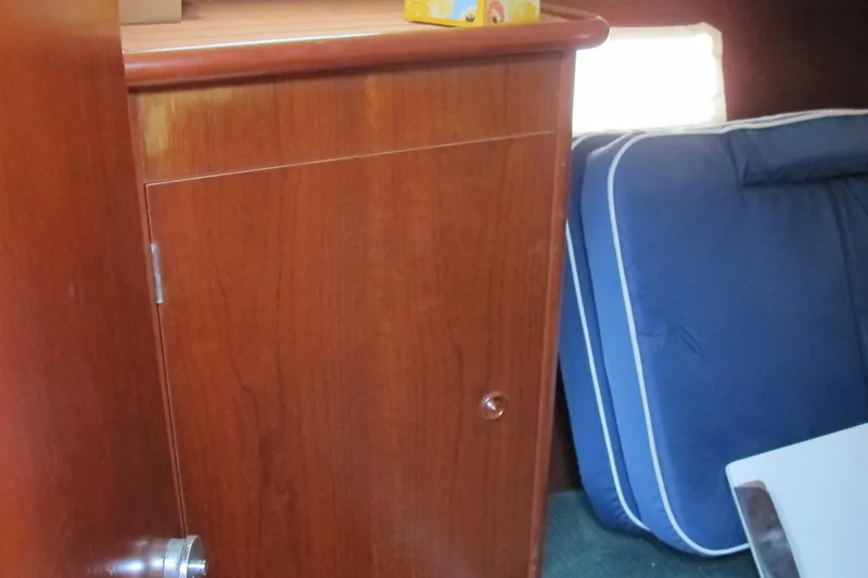 Slide: The Image of Interior of 2000 Beneteau Oceanis 361 yacht with wooden cabinet and blue cushions. - 17