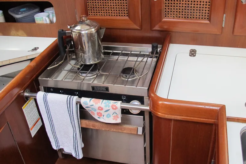 Slide: The Image of Galley kitchen in 2000 Beneteau Oceanis 361 sailboat with stove and kettle. - 21