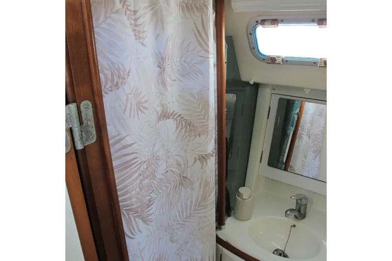 Slide: The Image of Bathroom interior of 2000 Beneteau Oceanis 361 sailboat with sink and shower curtain. - 25