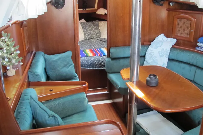 Slide: The Image of Interior of 2000 Beneteau Oceanis 361 sailboat with cozy seating and wooden finishes. - 29