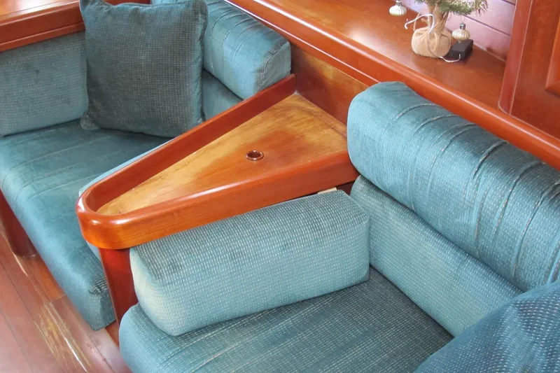 Slide: The Image of Interior of 2000 Beneteau Oceanis 361 yacht with teal cushions and wooden accents. - 33