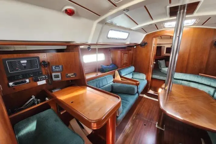 Slide: The Image of Interior of 2000 Beneteau Oceanis 361 sailboat with wood finish and seating area. - 40