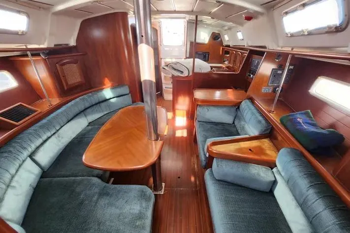 Slide: The Image of Interior of 2000 Beneteau Oceanis 361 sailboat with wood finish and blue seating. - 41