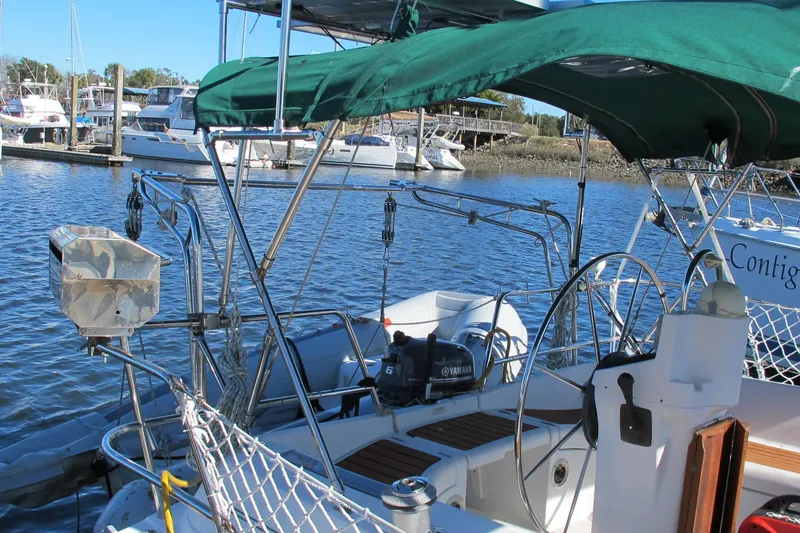 Slide: The Image of Beneteau Oceanis 361 sailboat, 2000 model, docked with green canopy and marina background. - 5