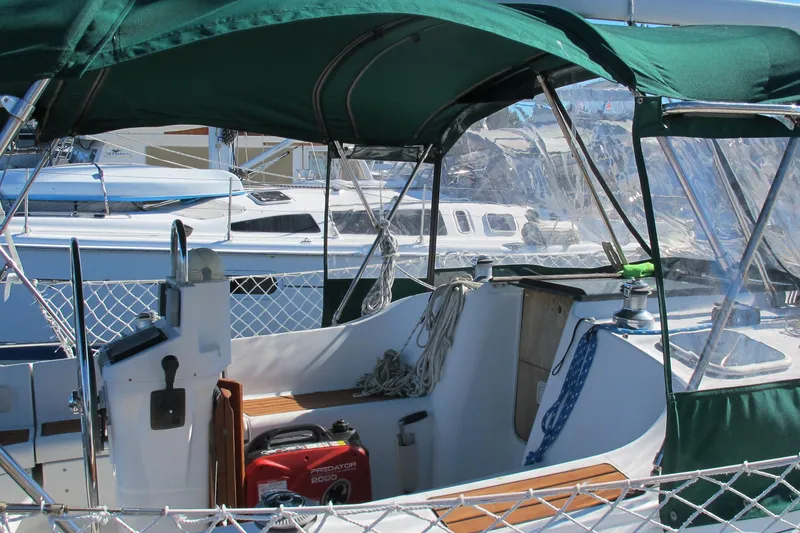 Slide: The Image of Cockpit of a 2000 Beneteau Oceanis 361 sailboat with green canopy and marina view. - 6