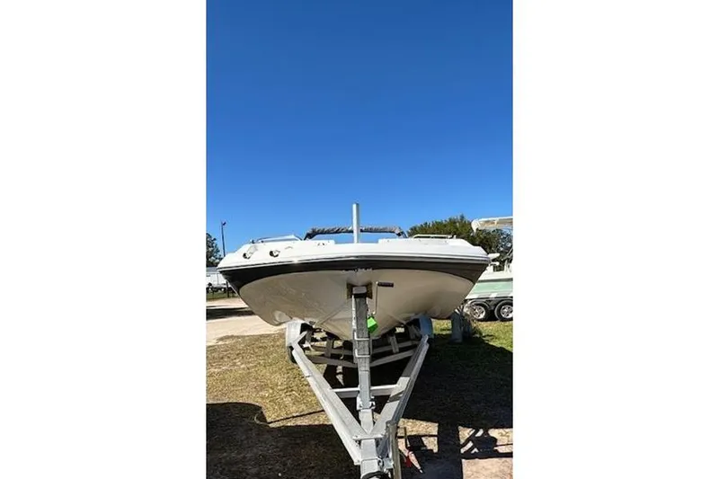 Slide: The Image of 2019 Hurricane SunDeck Sport 188 OB boat on trailer under clear blue sky. - 2