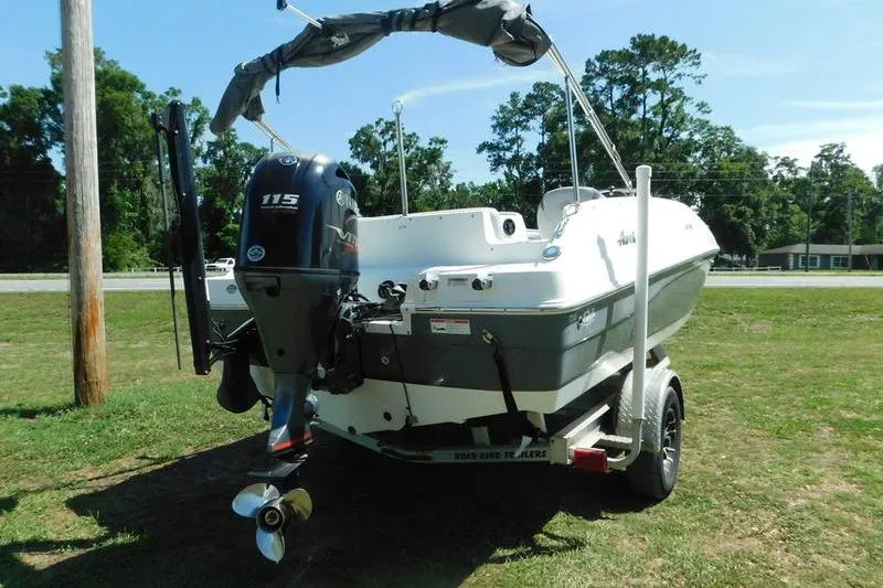 Slide: The Image of 2019 Hurricane SunDeck Sport 188 OB boat on trailer, parked on grass. - 7