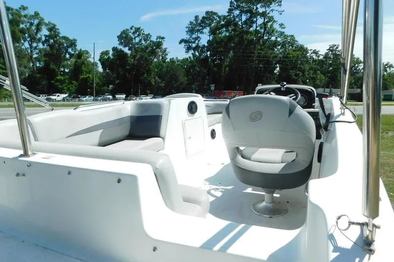 Slide: The Image of 2019 Hurricane SunDeck Sport 188 OB boat interior with seating and steering wheel. - 9