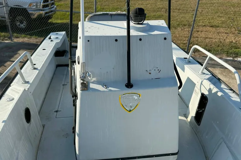 Slide: The Image of 2000 Boston Whaler Justice 24 boat interior with console and railing. - 12