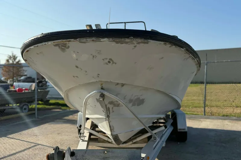 Slide: The Image of 2000 Boston Whaler Justice 24 boat on trailer, showing hull condition. - 5